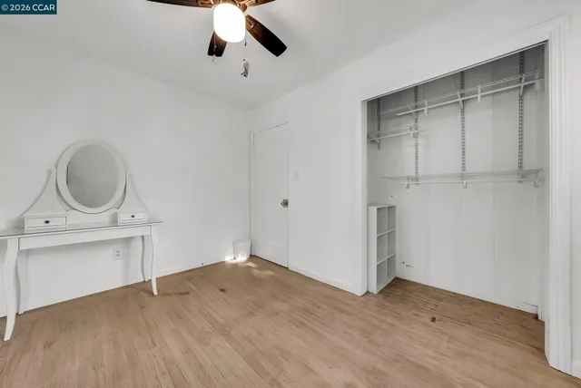 a view of a storage and utility room with wooden floor