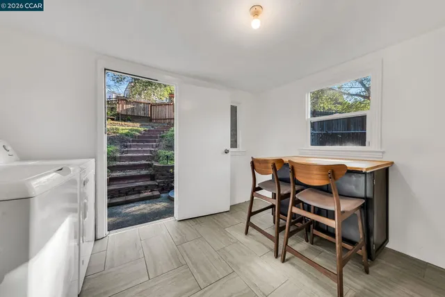 a dining room with furniture and window