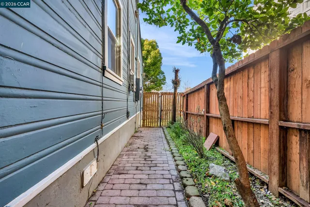 a view of balcony with wooden floor and fence and a potted plant