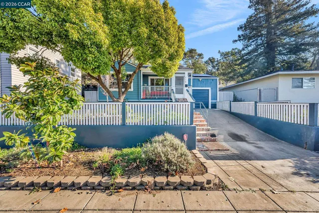 a view of a house with wooden fence