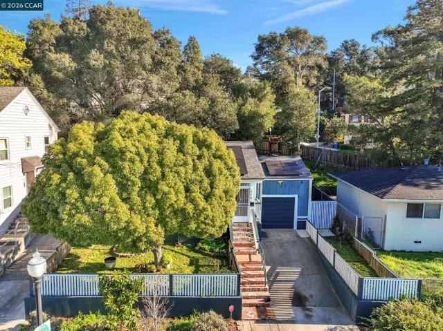 a view of swimming pool with outdoor seating and covered with trees
