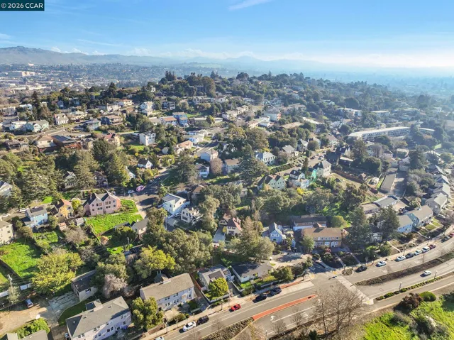 an aerial view of residential houses with city view