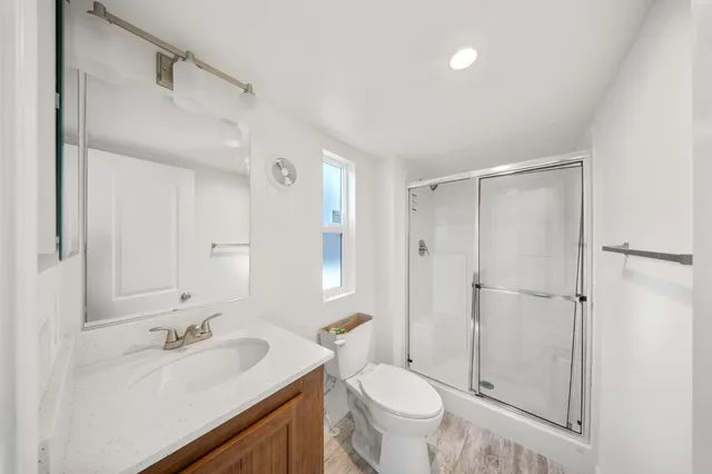 a bathroom with a sink toilet and shower