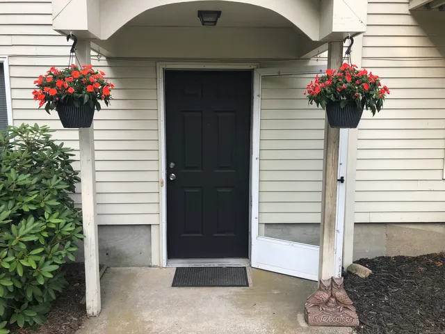 a flower garden is sitting in front of a house