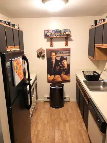 a kitchen with stainless steel appliances a stove a sink and a refrigerator