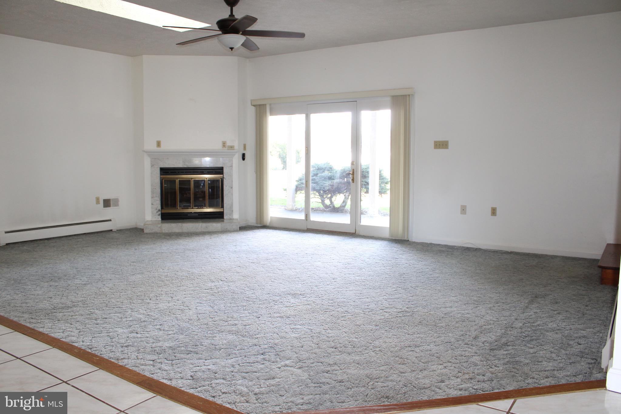 2485 Joppa Road York, PA 17403 - Photo 11 of 14 a view of an empty room with a fireplace and a window