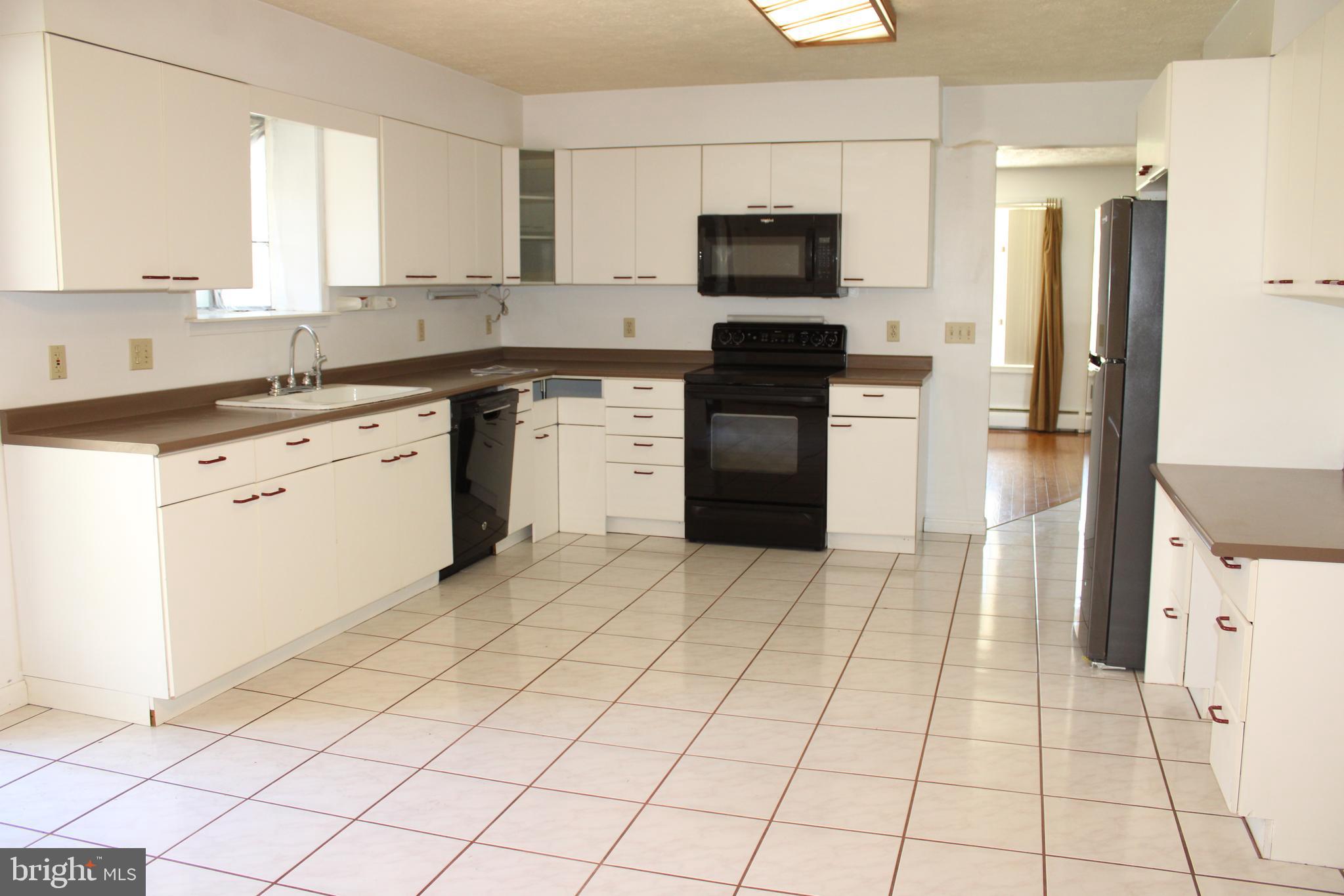 2485 Joppa Road York, PA 17403 - Photo 14 of 14 a kitchen with a sink a stove and refrigerator