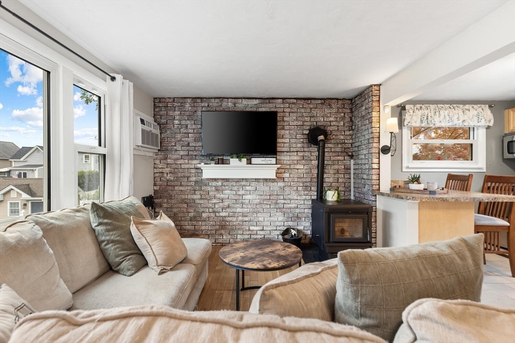 12 Wright Street, Unit 2 Stoneham, MA 02180 - Photo 11 of 35 a living room with furniture a large window and a flat screen tv