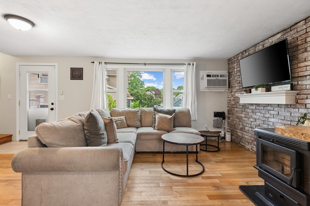 12 Wright Street, Unit 2 Stoneham, MA 02180 - Photo 13 of 35 a living room with furniture and a flat screen tv
