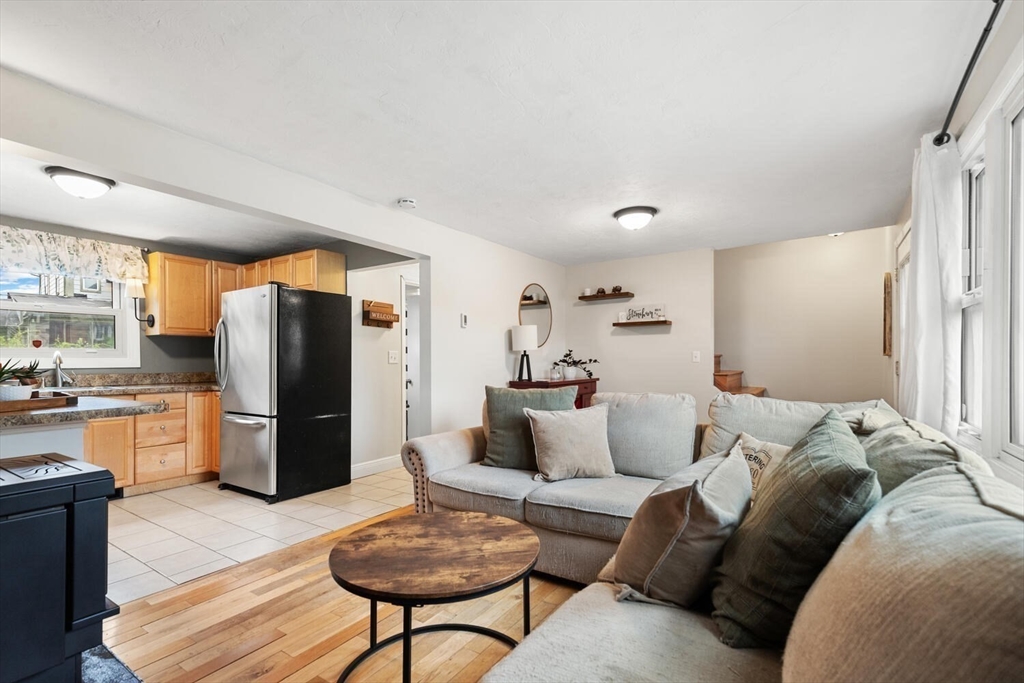 12 Wright Street, Unit 2 Stoneham, MA 02180 - Photo 14 of 35 a living room with furniture and a refrigerator