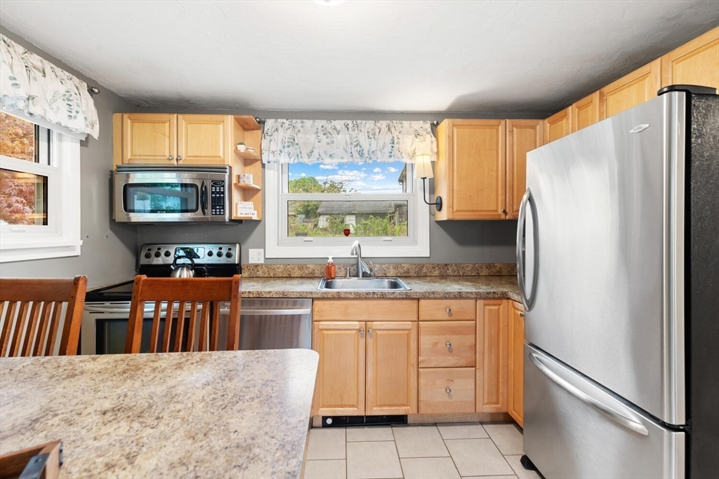 12 Wright Street, Unit 2 Stoneham, MA 02180 - Photo 16 of 35 a kitchen with stainless steel appliances granite countertop a refrigerator and a stove top oven