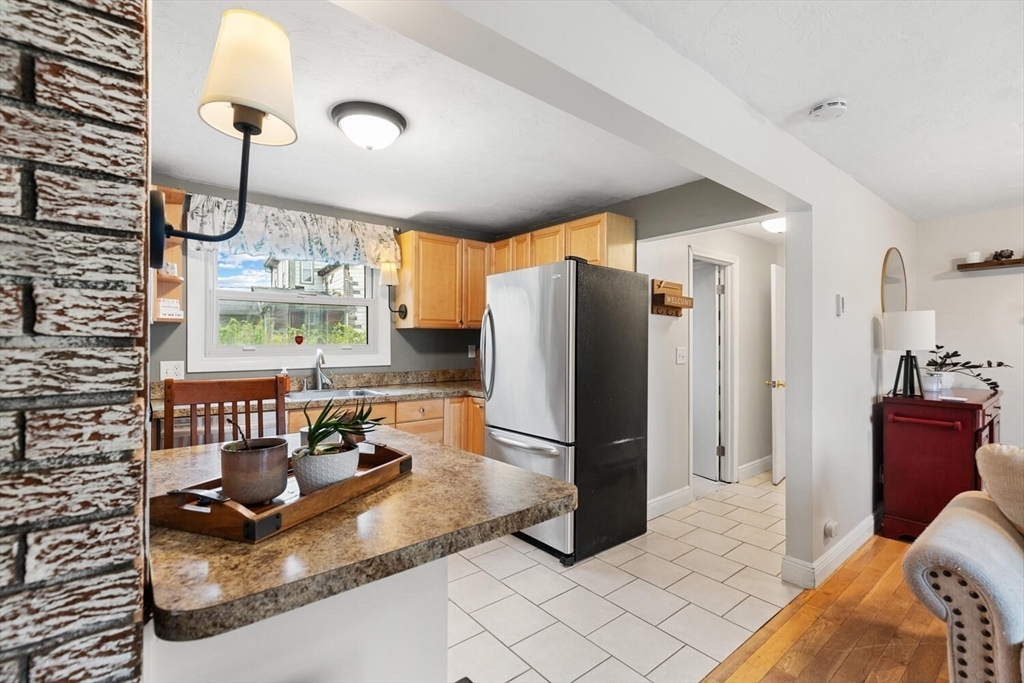 12 Wright Street, Unit 2 Stoneham, MA 02180 - Photo 17 of 35 a kitchen with granite countertop a refrigerator and a sink
