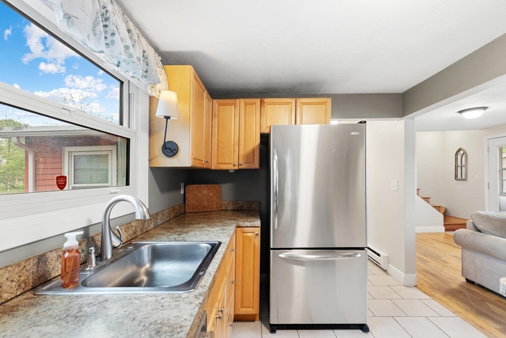 12 Wright Street, Unit 2 Stoneham, MA 02180 - Photo 19 of 35 a kitchen with stainless steel appliances granite countertop a refrigerator and a sink