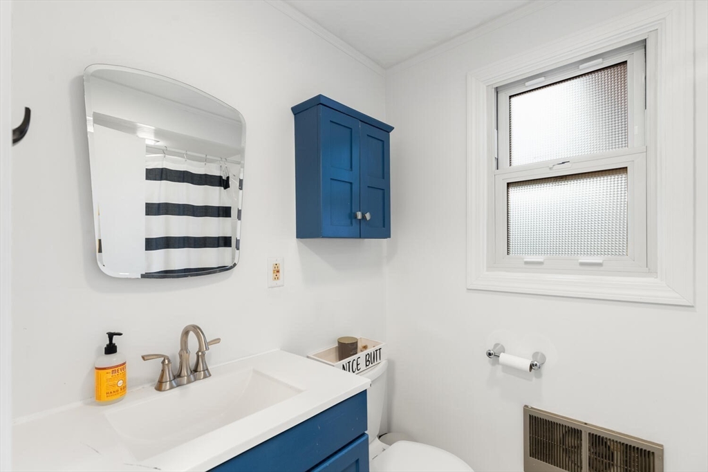 12 Wright Street, Unit 2 Stoneham, MA 02180 - Photo 20 of 35 a bathroom with a sink a toilet and mirror