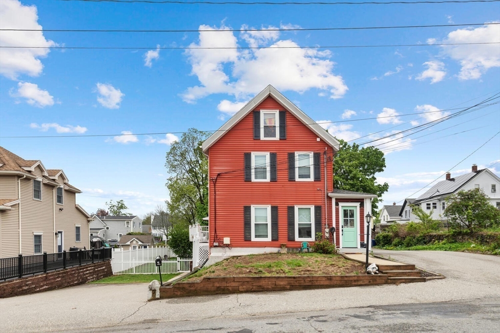 12 Wright Street, Unit 2 Stoneham, MA 02180 - Photo 2 of 35 a front view of a house with a yard