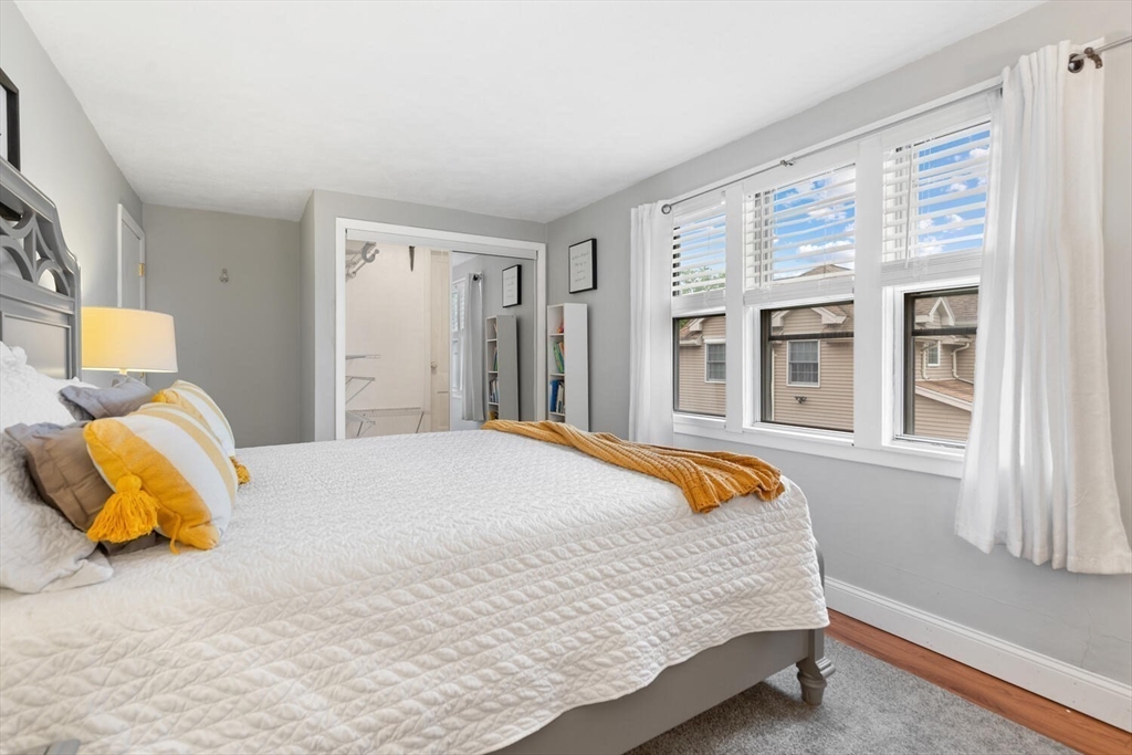 12 Wright Street, Unit 2 Stoneham, MA 02180 - Photo 26 of 35 a bedroom with a bed and wooden floor