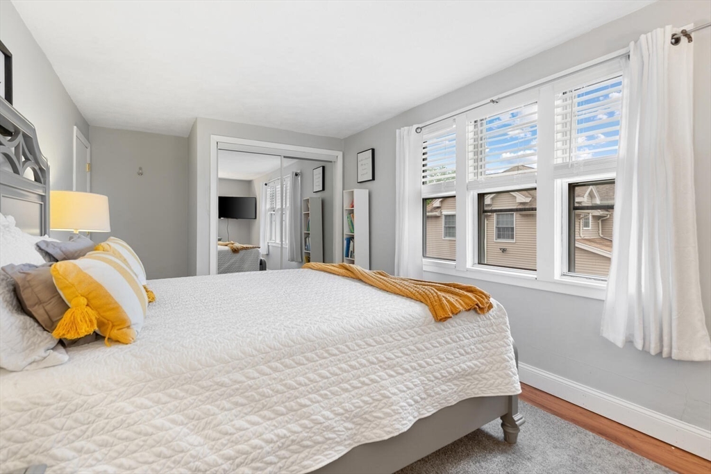 12 Wright Street, Unit 2 Stoneham, MA 02180 - Photo 27 of 35 a bedroom with a bed and lamp