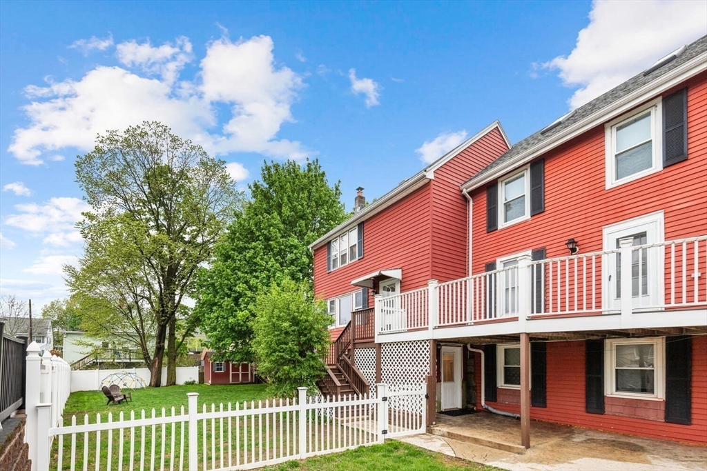 12 Wright Street, Unit 2 Stoneham, MA 02180 - Photo 3 of 35 a view of a house with a yard and plants