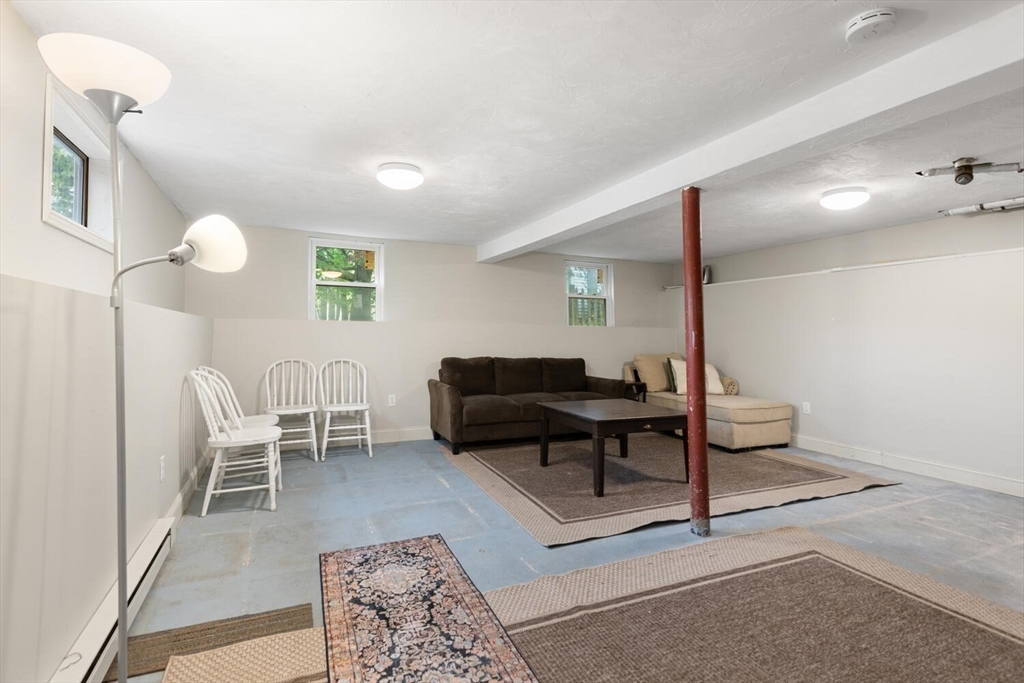 12 Wright Street, Unit 2 Stoneham, MA 02180 - Photo 31 of 35 a living room with furniture a rug and a lamp