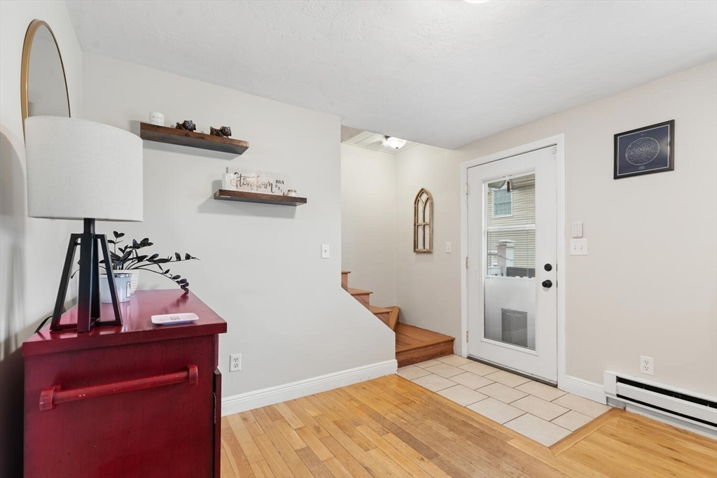 12 Wright Street, Unit 2 Stoneham, MA 02180 - Photo 9 of 35 a view of a livingroom with wooden floor and stairs