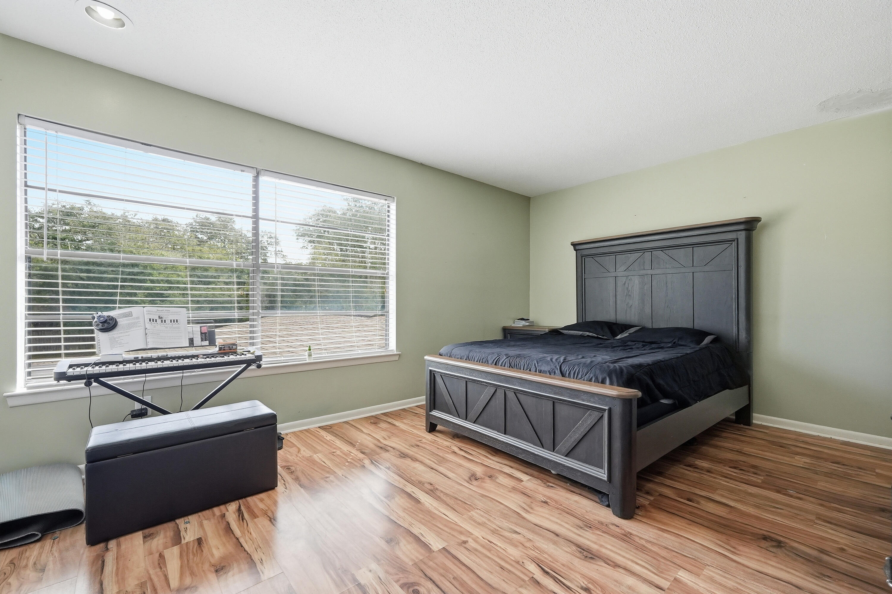41 12th Street, Unit 68 Shalimar, FL 32579 - Photo 12 of 32 a bedroom with a bed and wooden floor