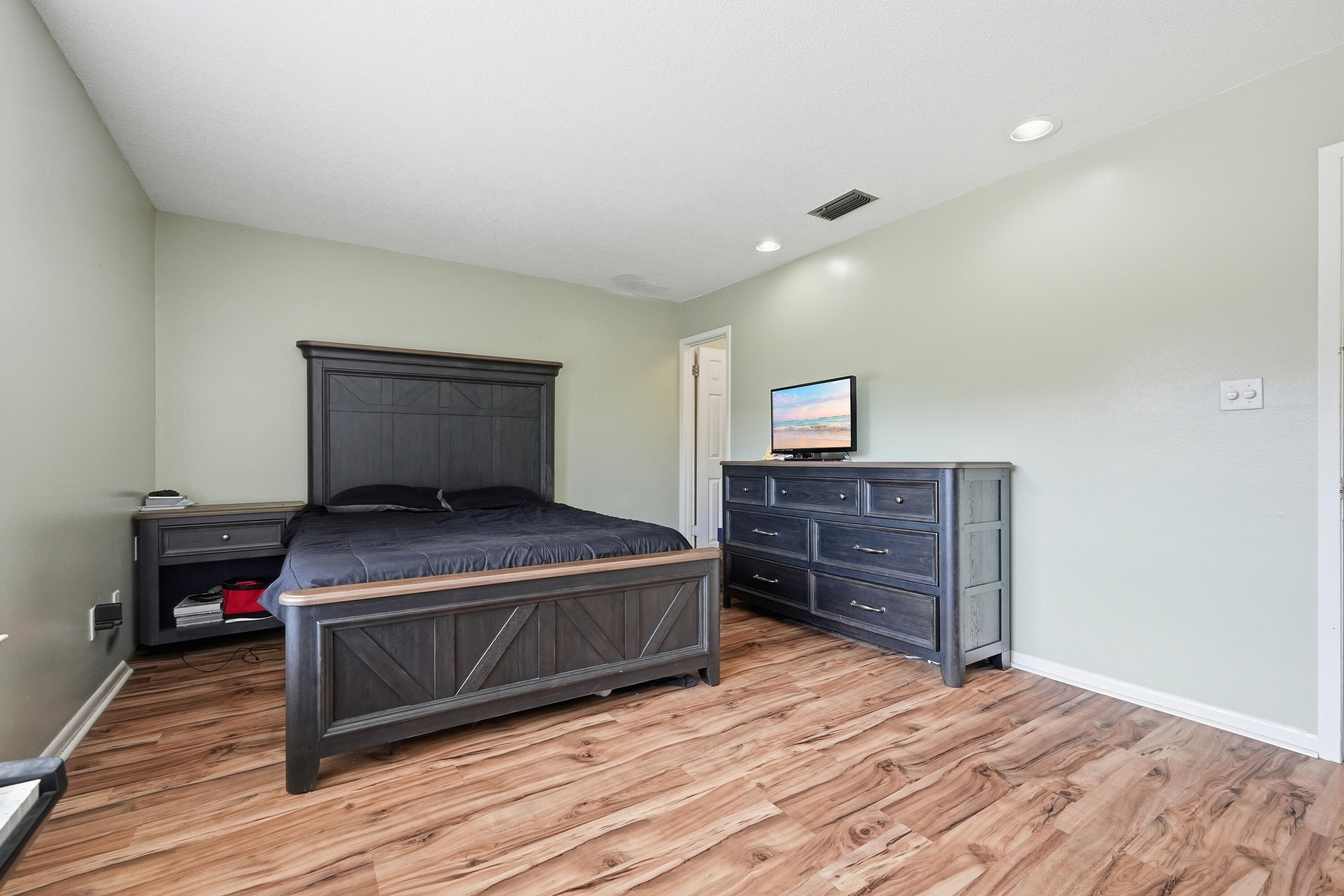 41 12th Street, Unit 68 Shalimar, FL 32579 - Photo 13 of 32 a bedroom with a bed and wooden floor