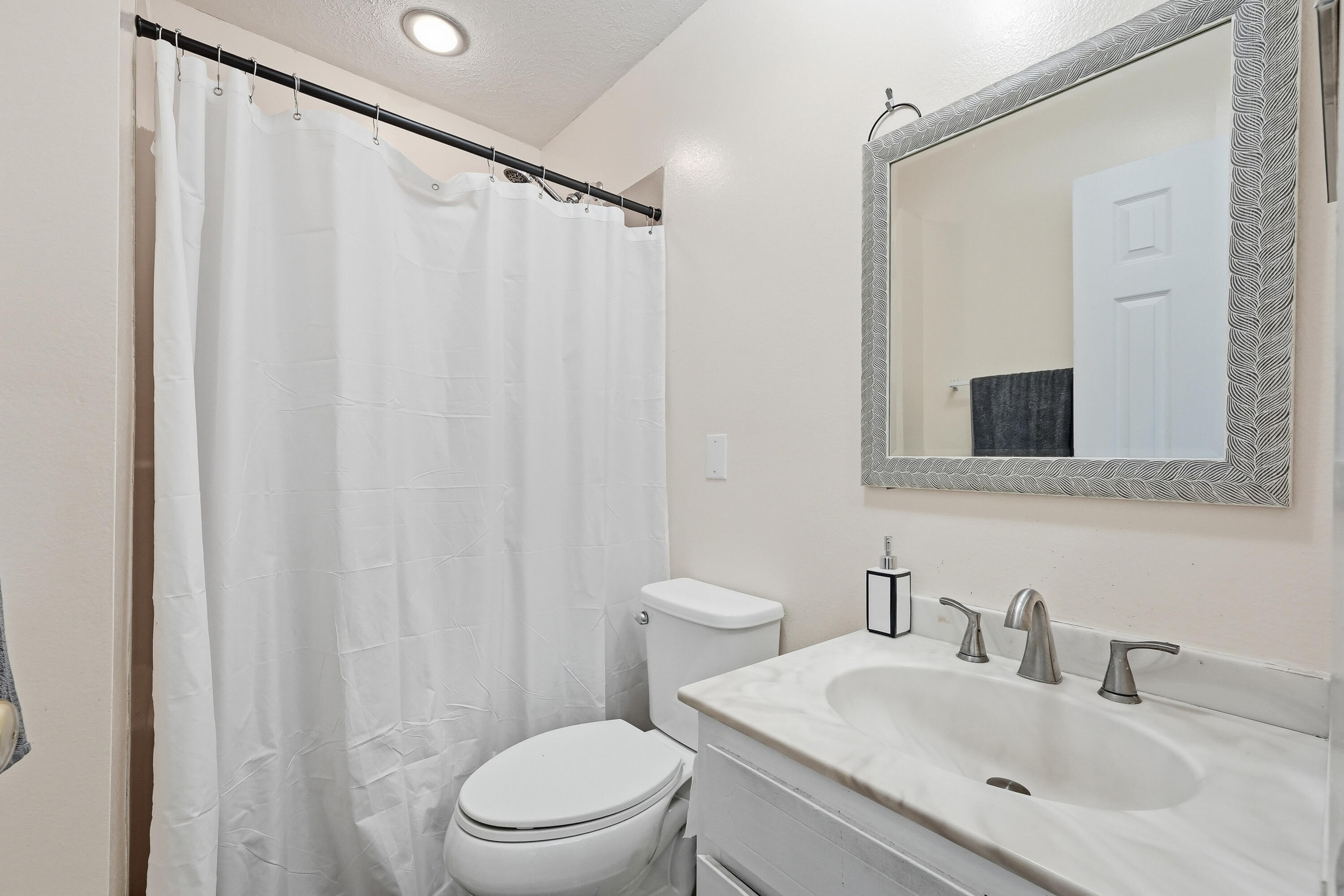 41 12th Street, Unit 68 Shalimar, FL 32579 - Photo 14 of 32 a bathroom with a granite countertop sink and a mirror