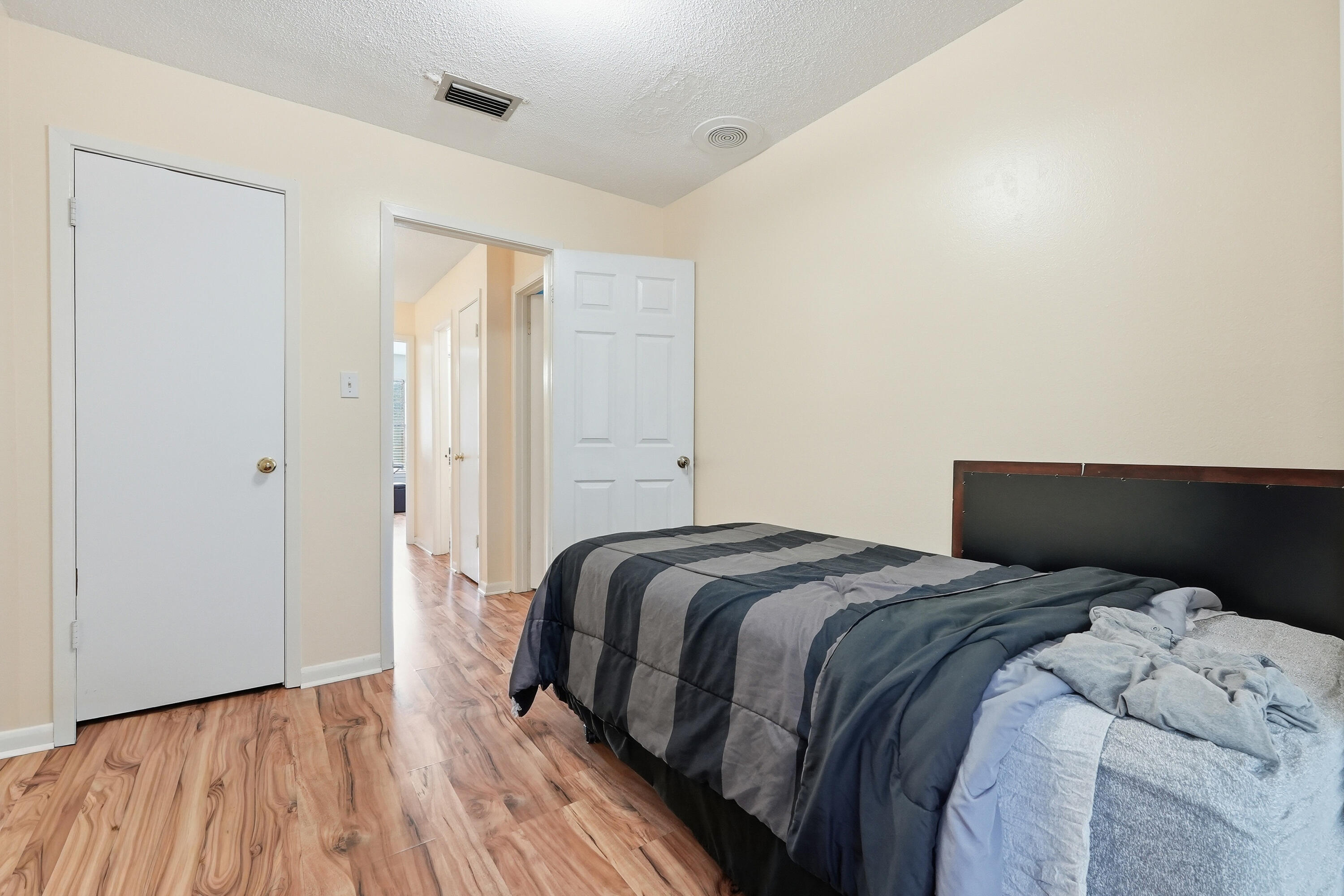 41 12th Street, Unit 68 Shalimar, FL 32579 - Photo 21 of 32 a bedroom with a bed and wooden floor