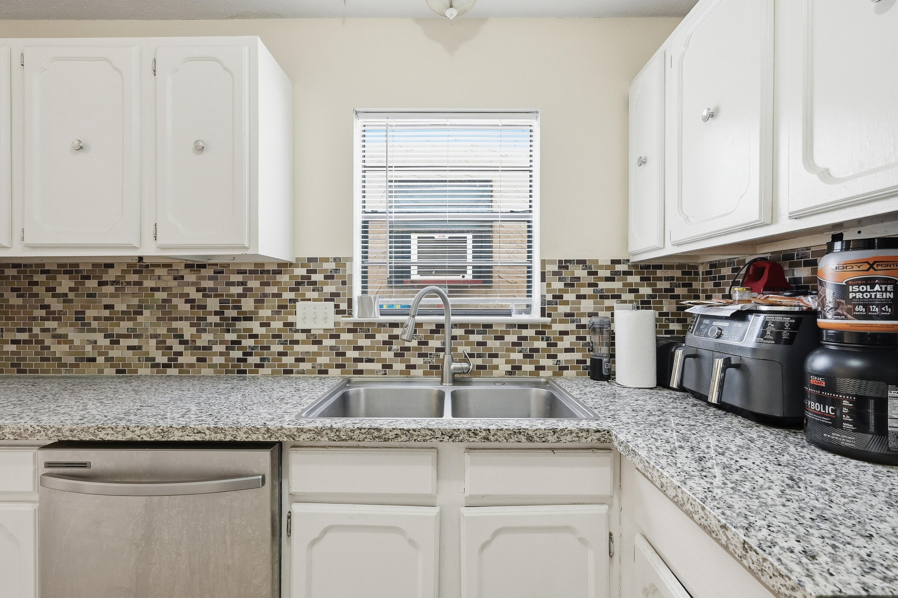 41 12th Street, Unit 68 Shalimar, FL 32579 - Photo 4 of 32 a kitchen with stainless steel appliances granite countertop a sink a stove and cabinets