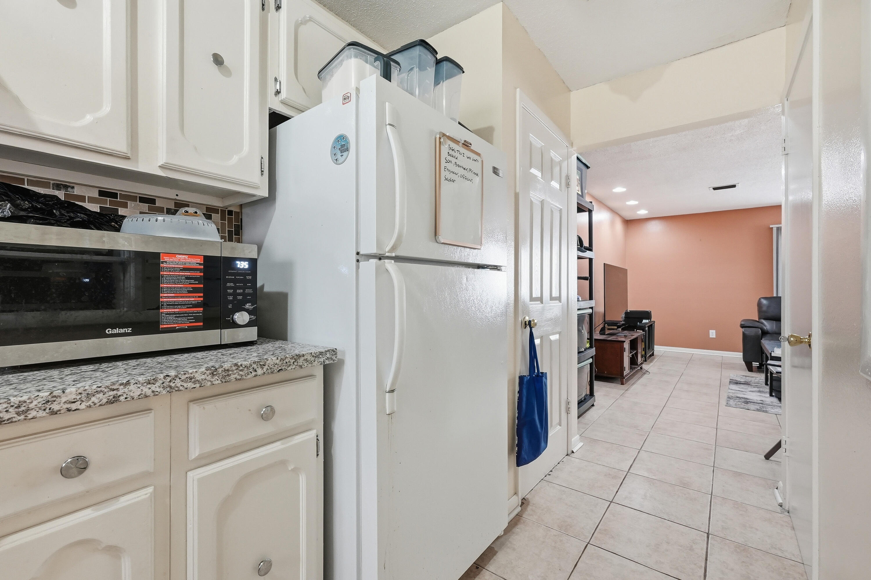 41 12th Street, Unit 68 Shalimar, FL 32579 - Photo 6 of 32 a kitchen with granite countertop a refrigerator and a stove top oven