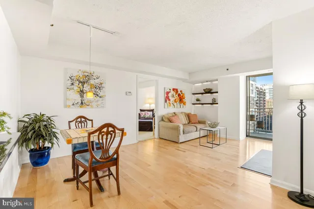 a living room with furniture and floor to ceiling window