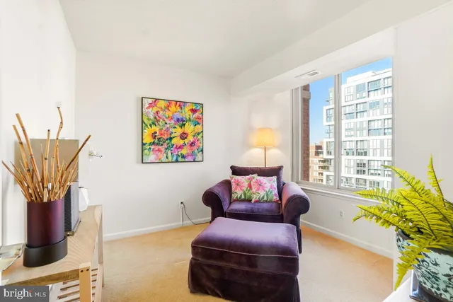a living room with furniture a fireplace and a potted plant