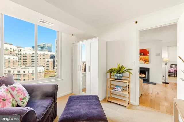 a bedroom with furniture and a large window