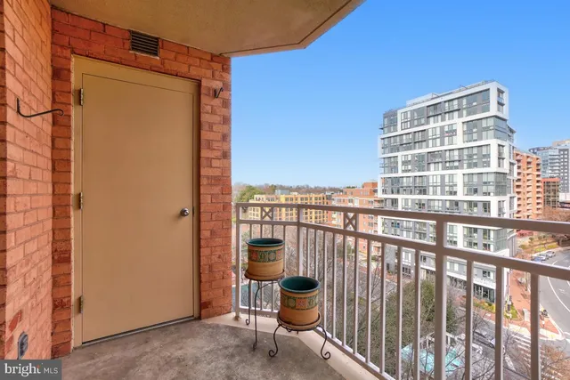 a view of a balcony with chair and city view