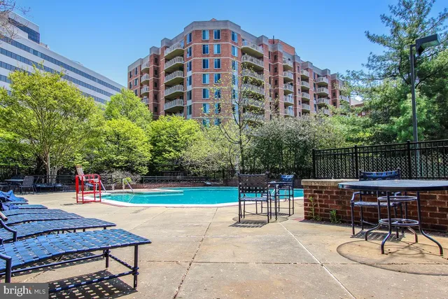 a view of a backyard with couches and wooden fence