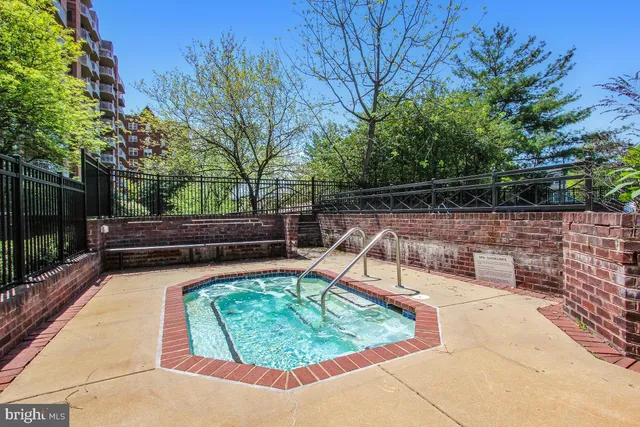 a view of a patio with table and chairs under an umbrella