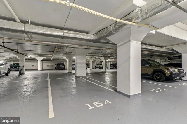 a view of a tennis ground with large buildings
