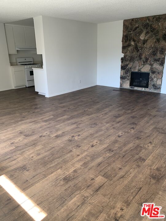 11525 Rochester Avenue, Unit 204 Los Angeles, CA 90025 - Photo 2 of 8 a view of kitchen and empty room with fireplace