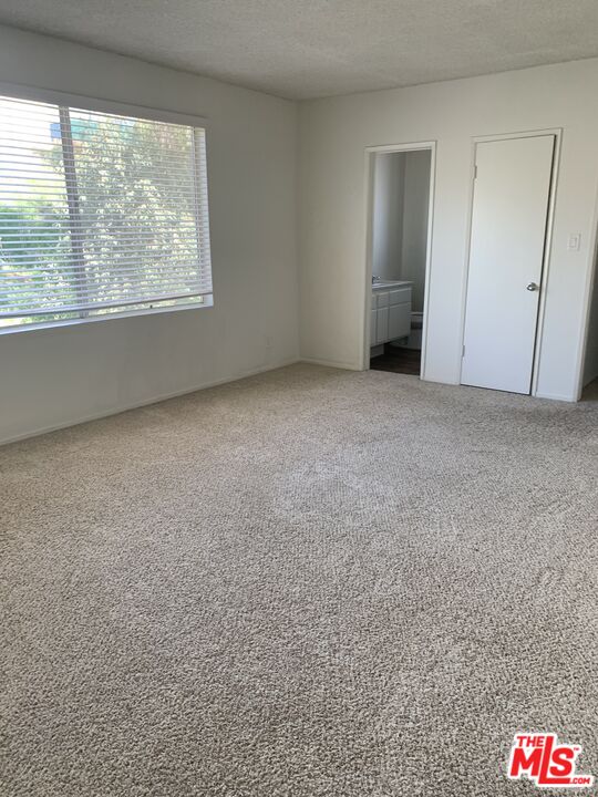 11525 Rochester Avenue, Unit 204 Los Angeles, CA 90025 - Photo 7 of 8 an empty room with a empty space and windows