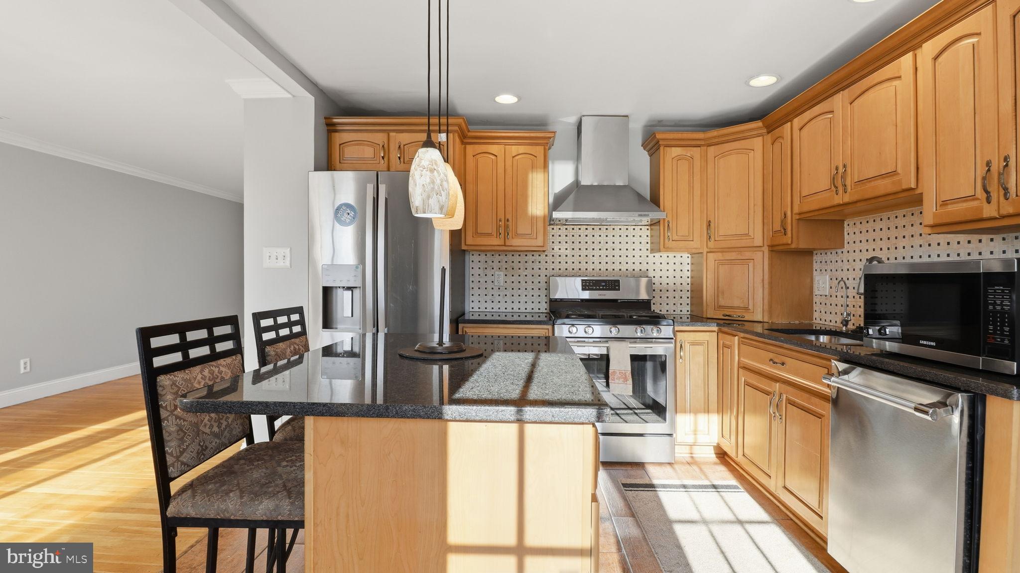 1703 Tioga Road Fort Washington, MD 20744 - Photo 15 of 57 Modern kitchen with warm wood cabinetry.