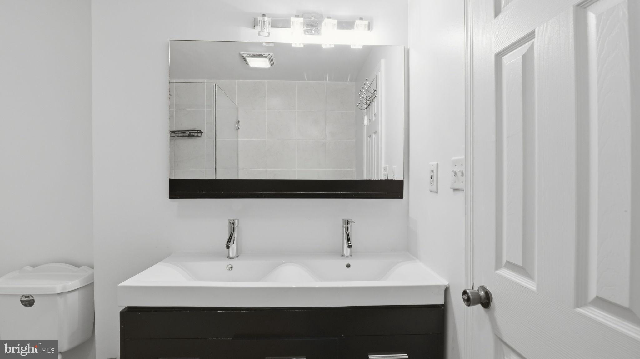 1703 Tioga Road Fort Washington, MD 20744 - Photo 31 of 57 Sleek modern bathroom with dual sinks.