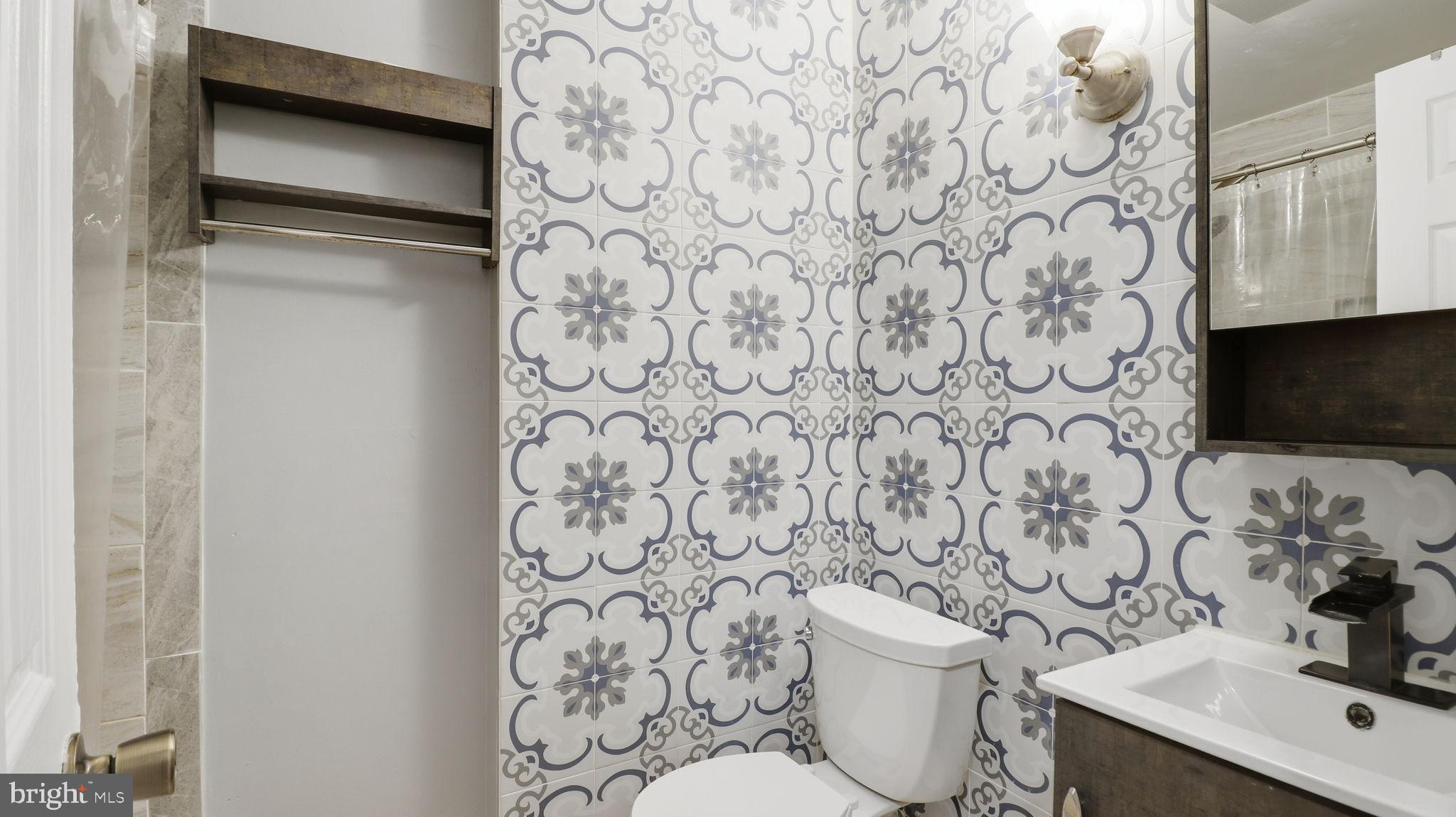 1703 Tioga Road Fort Washington, MD 20744 - Photo 40 of 57 Charming bathroom with vibrant tile design.