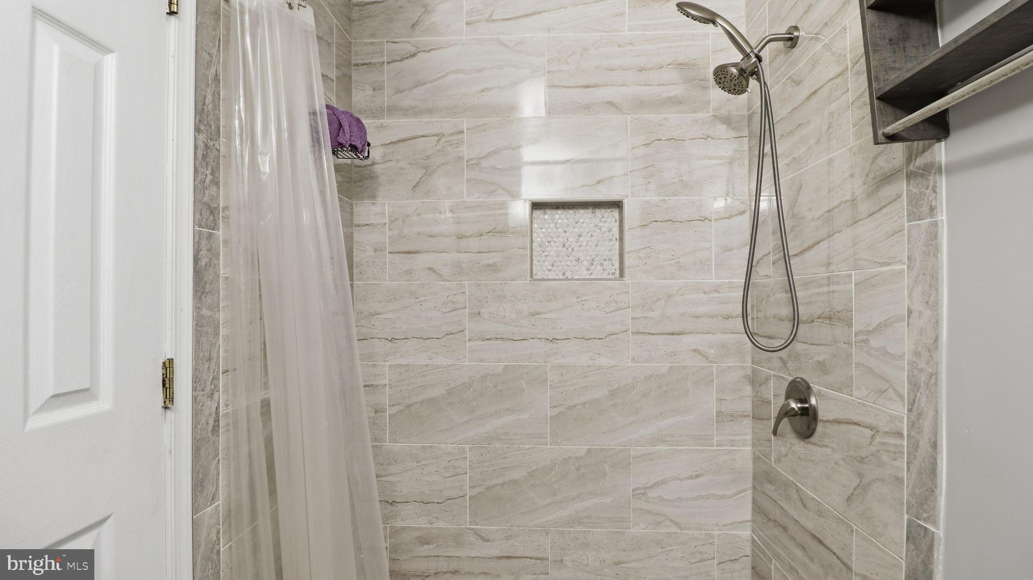 1703 Tioga Road Fort Washington, MD 20744 - Photo 41 of 57 Sleek modern shower with elegant tiles.