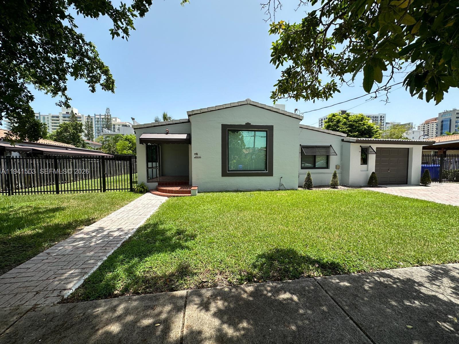 3050 Southwest 21st Street Miami, FL 33145 - Photo 2 of 38 a front view of a house with garden