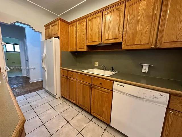 a kitchen with stainless steel appliances a stove a sink and cabinets
