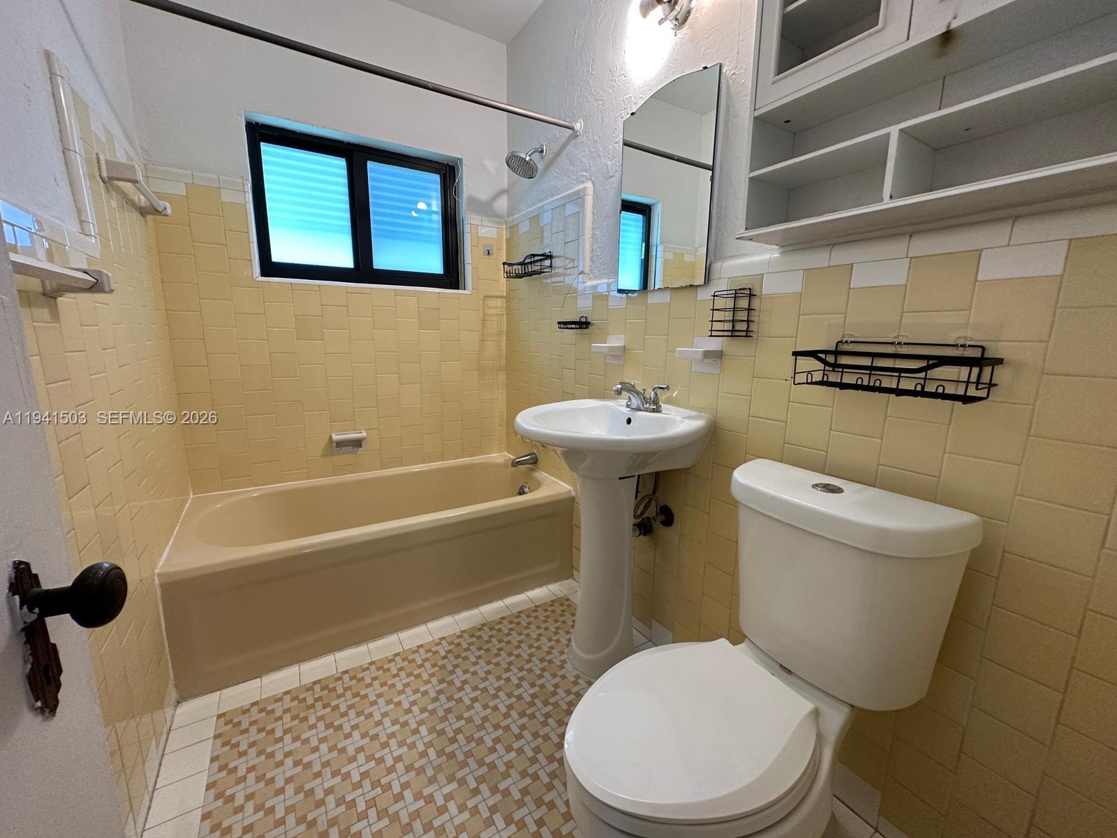 3050 Southwest 21st Street Miami, FL 33145 - Photo 33 of 38 a white toilet sitting next to a bath tub