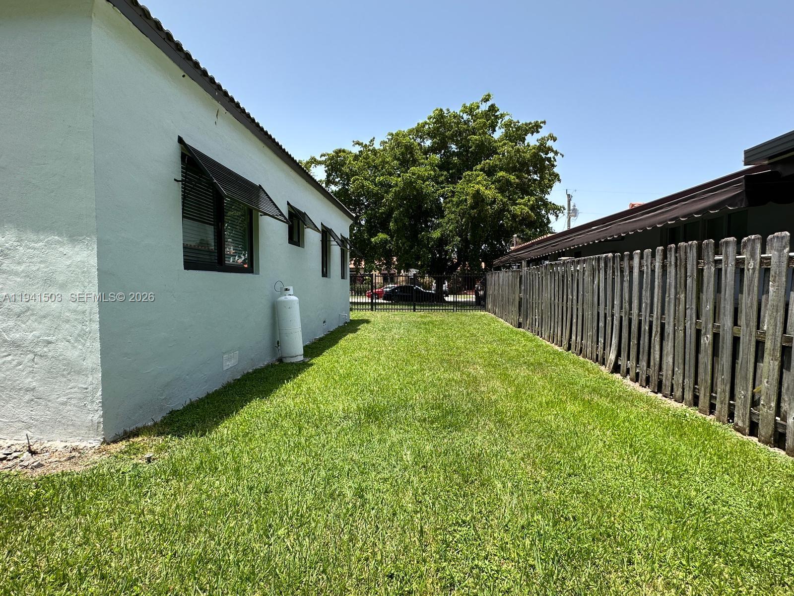 3050 Southwest 21st Street Miami, FL 33145 - Photo 10 of 38 a backyard of a house with table and chairs