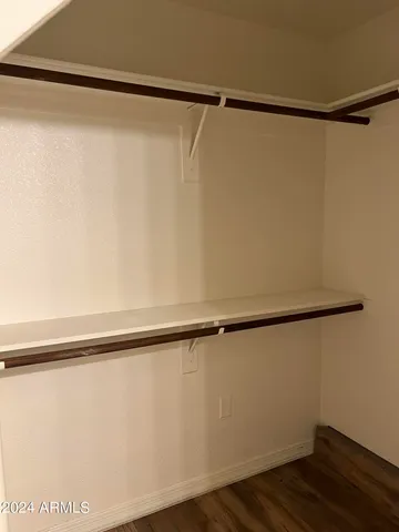 a view of a room with wooden floor and a window in it