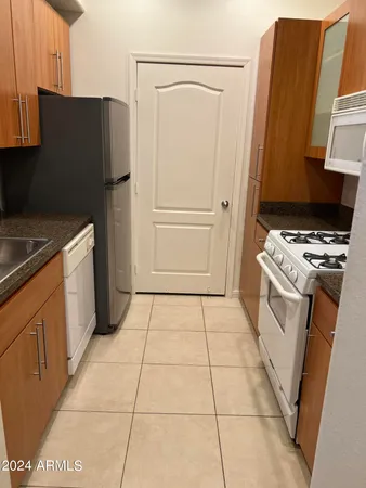 a kitchen with a stove top oven and cabinets