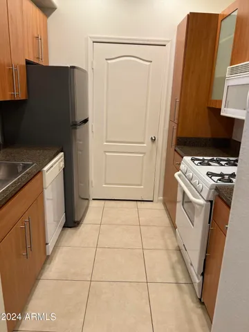 a kitchen with a stove top oven and cabinets